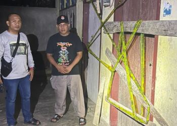 Petugas memasang garis polisi di Lorong Jahit, Jambi. (foto/doc)