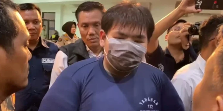 Tersangka saat berada di Polres Metro Jakarta Timur (foto/doc)