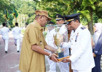 Bupati Langkat Syah Afandin serahkan penghargaan kepada Camat Besitang H. Irham Efendi. (Foto/Doc).